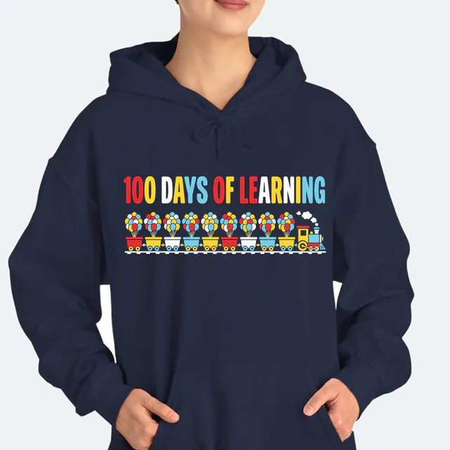 A train of ten cars carrying balloons, 100 DAYS OF LEARNING, on a navy adult hoodie