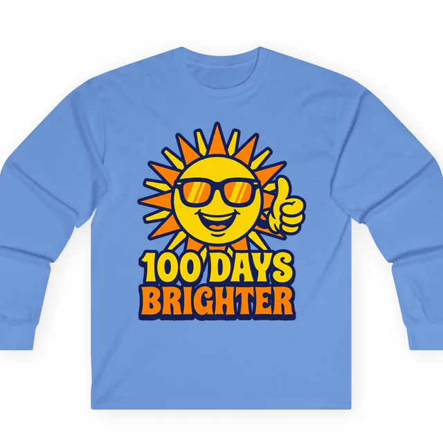 A sun in sunglasses giving a thumbs-up, 100 DAYS BRIGHTER, on a carolina blue adult long sleeve