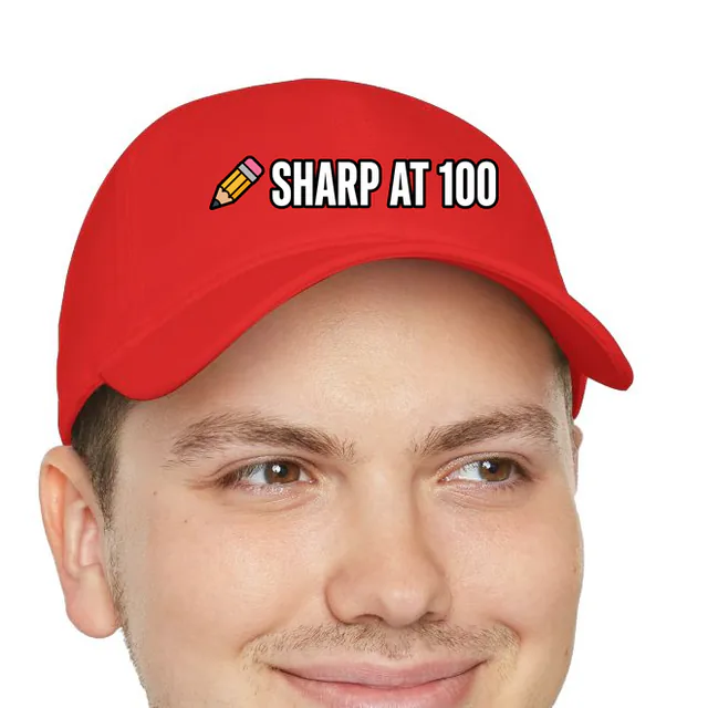 A sharpened pencil beside SHARP AT 100, on a red dad hat