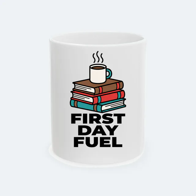 Steaming coffee on a stack of textbooks, FIRST DAY FUEL, on a white ceramic mug