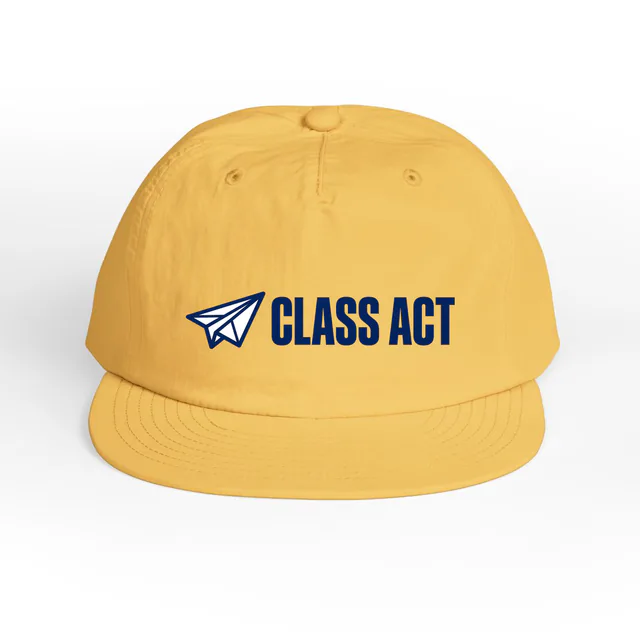 A paper airplane beside CLASS ACT, on a sunset surf cap