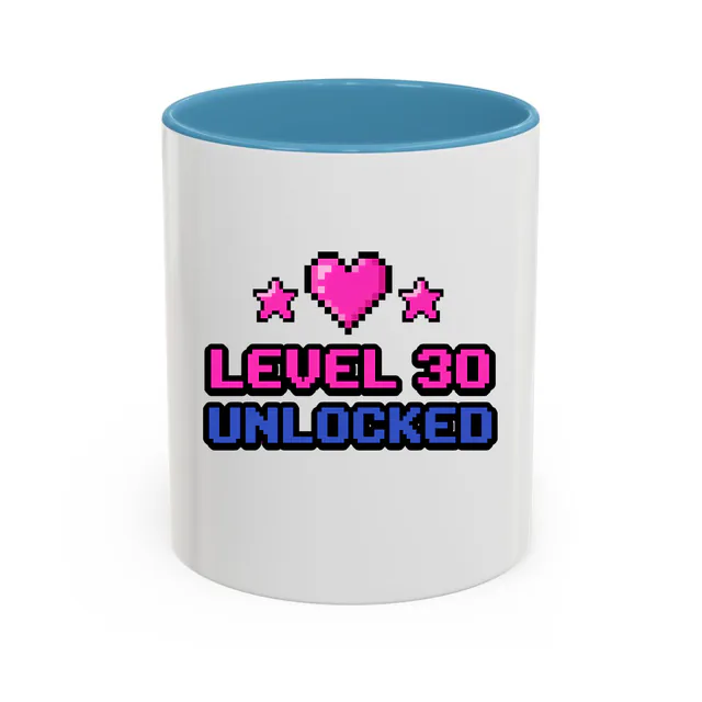 Pixel hearts and stars, LEVEL 30 UNLOCKED, on a light blue accent mug