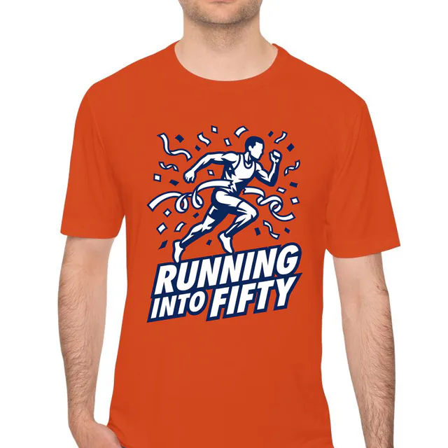 A runner breaking a streamer finish tape, RUNNING INTO FIFTY, on an orange performance tee