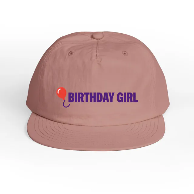 A balloon beside BIRTHDAY GIRL, on a hazy pink surf cap