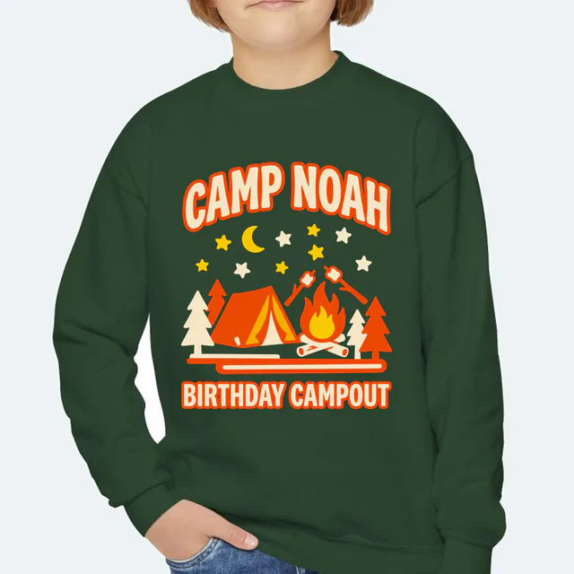 A tent and a campfire under the stars, CAMP NOAH, on a forest green youth crewneck