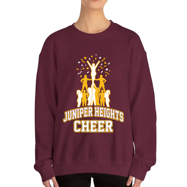 A stunt pyramid in a burst of confetti, JUNIPER HEIGHTS CHEER, on a maroon adult crewneck