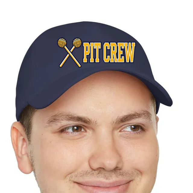 Crossed marimba mallets beside PIT CREW, on a navy dad hat