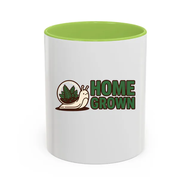 A snail with a terrarium for a shell, HOME GROWN, on a light green accent mug