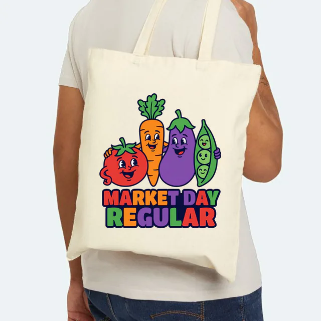 Smiling vegetables lined up for a photo, MARKET DAY REGULAR, on a natural canvas tote
