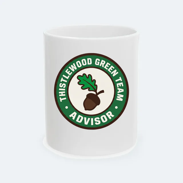 A sprouting acorn badge for the Thistlewood green team advisor, on a white ceramic mug