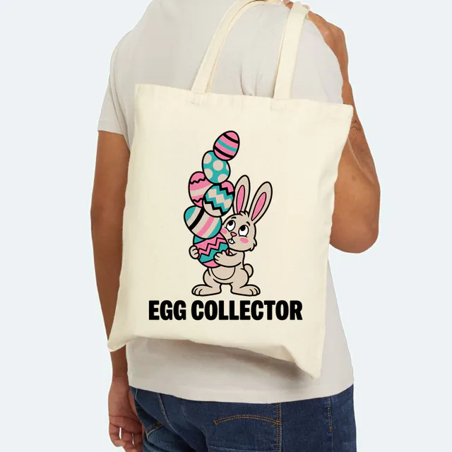 A bunny balancing a tower of eggs, EGG COLLECTOR, on a natural canvas tote