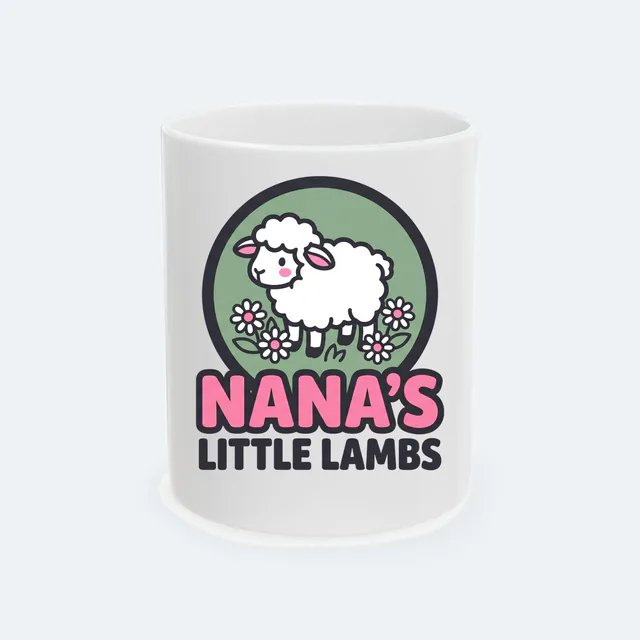 A lamb among daisies for NANA'S LITTLE LAMBS, on a white ceramic mug