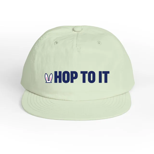 A pair of bunny ears beside HOP TO IT, on a mint surf cap