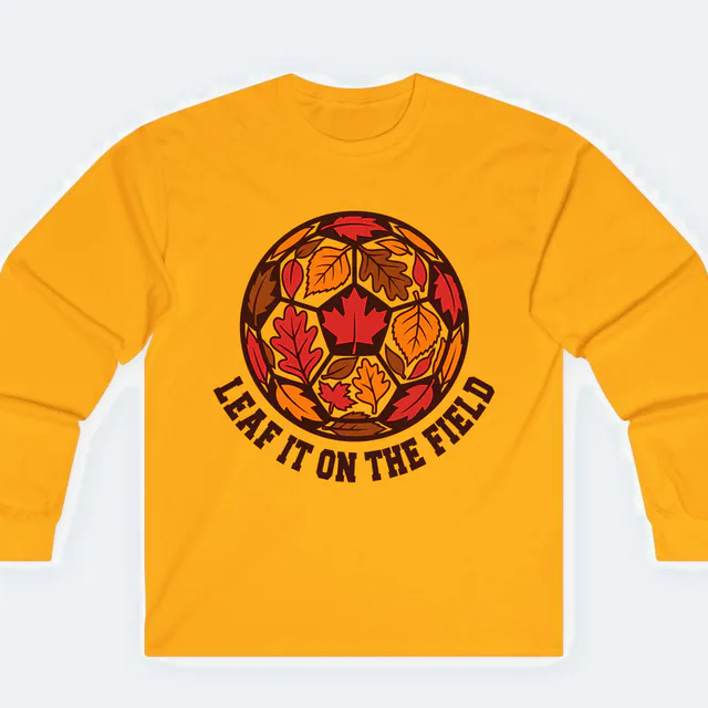 A soccer ball of stitched autumn leaves, LEAF IT ON THE FIELD, on a gold adult long sleeve