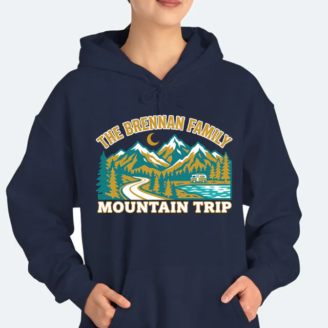 A camper van by a mountain lake for the Brennan family, on a navy adult hoodie