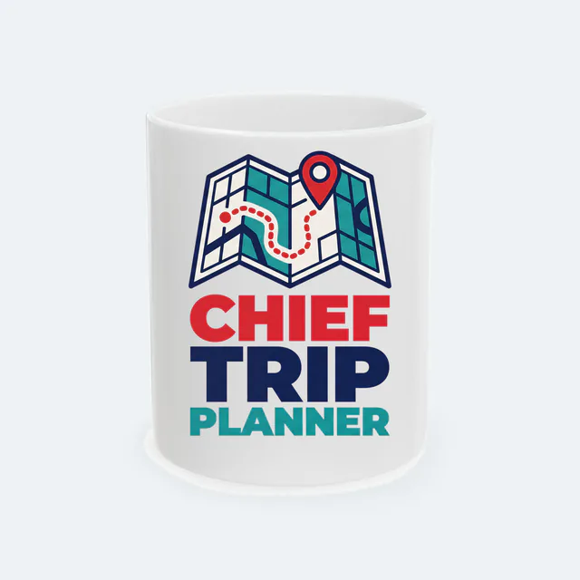 A folded map with a red pin, CHIEF TRIP PLANNER, on a white ceramic mug
