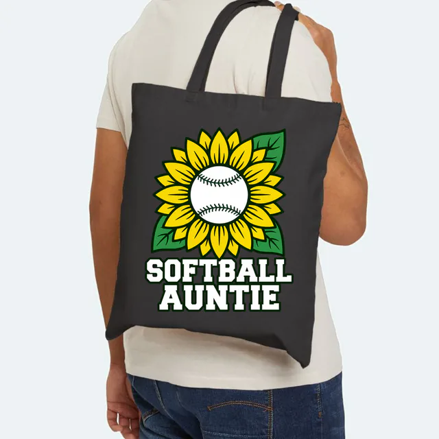 A sunflower with a softball center, SOFTBALL AUNTIE, on a black canvas tote