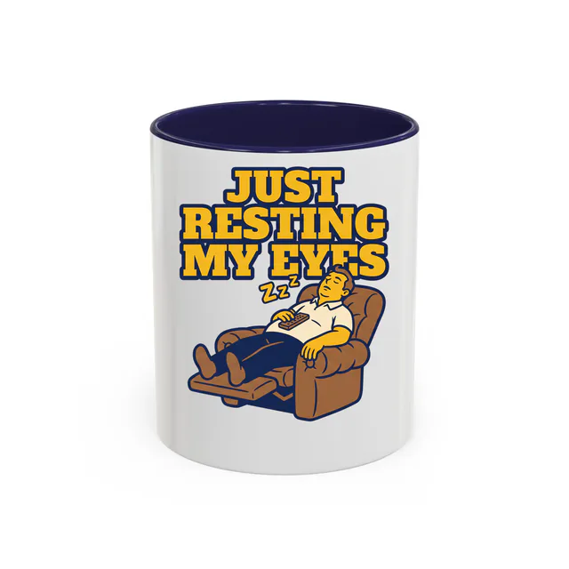 A dad snoozing in his recliner, JUST RESTING MY EYES, on a navy accent mug