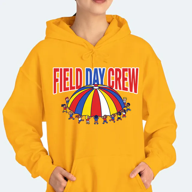 Kids lifting a rainbow parachute, FIELD DAY CREW, on a gold adult hoodie