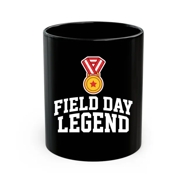 A gold medal on a striped ribbon, FIELD DAY LEGEND, on a black mug