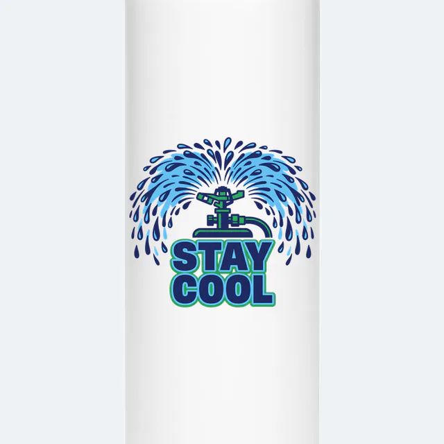 A sprinkler throwing an arc of water, STAY COOL, on a white steel tumbler
