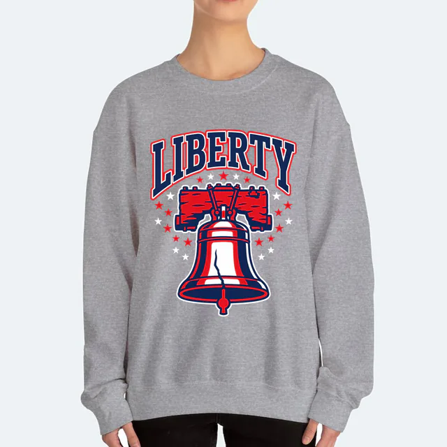 The Liberty Bell under LIBERTY in tall retro letters, on a sport gray adult crewneck