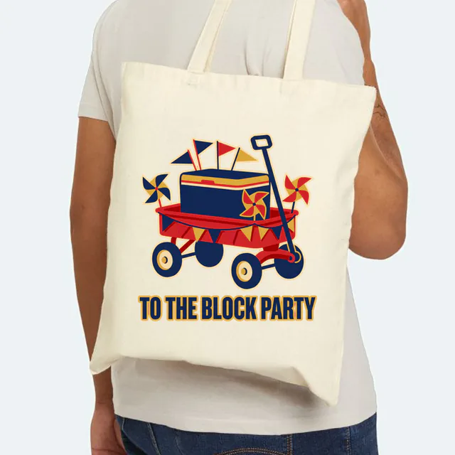A red wagon loaded with flags, TO THE BLOCK PARTY, on a natural canvas tote