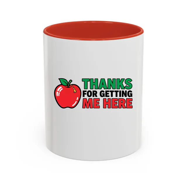 An apple wearing a tassel, THANKS FOR GETTING ME HERE, on a red accent mug