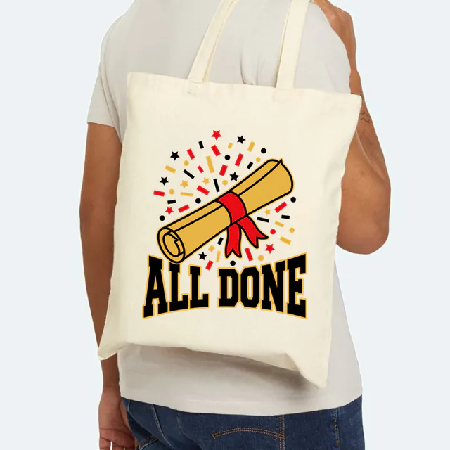 A rolled diploma over a burst of confetti, ALL DONE, on a natural canvas tote