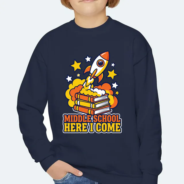 A rocket launching off a stack of books, MIDDLE SCHOOL HERE I COME, on a navy youth crewneck