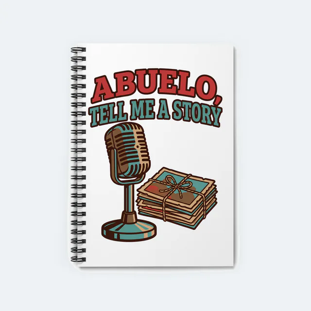 A vintage microphone and old photos, ABUELO, TELL ME A STORY, on a white spiral notebook