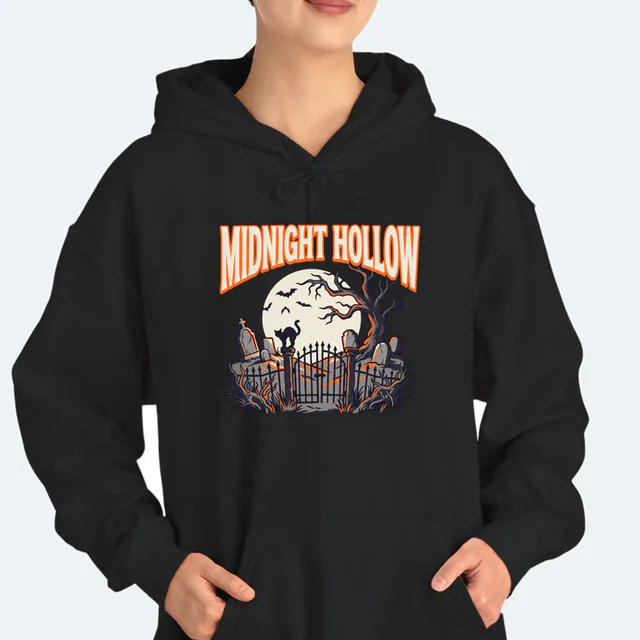 A moonlit graveyard and a cat on the gate under MIDNIGHT HOLLOW, on a black adult hoodie