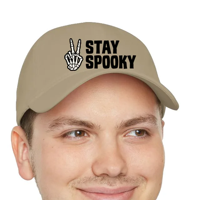 A skeleton hand making a peace sign, STAY SPOOKY, on a khaki dad hat