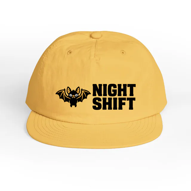 A little bat beside NIGHT SHIFT, on a sunset surf cap