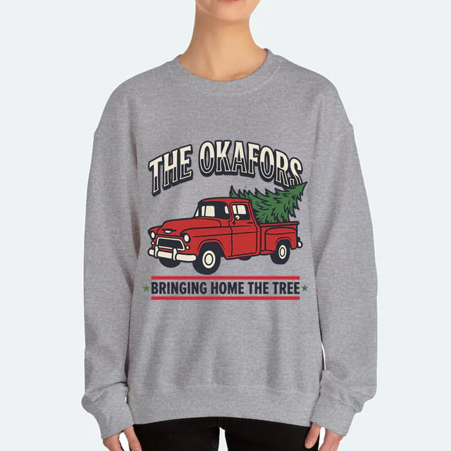 A red pickup bringing the tree home for the Okafors, on a sport gray adult crewneck