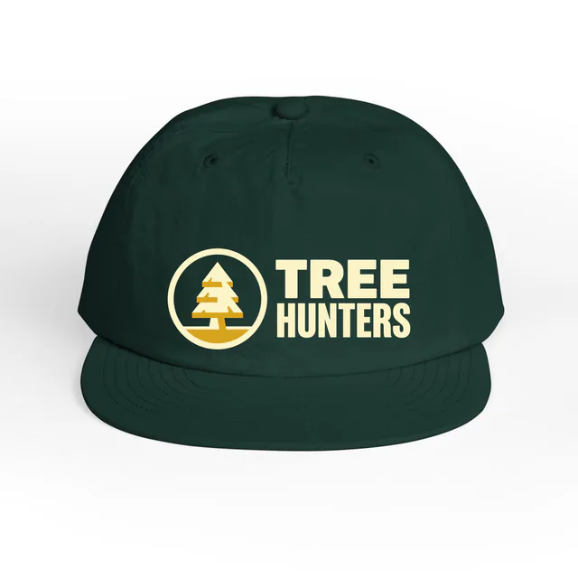 A pine tree badge beside TREE HUNTERS, on a pine green surf cap