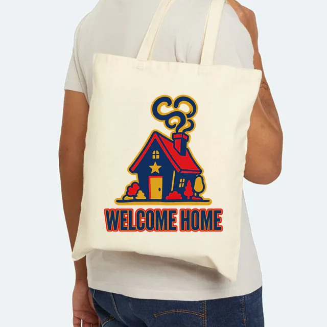 A cozy house with a star over the door, WELCOME HOME, on a natural canvas tote