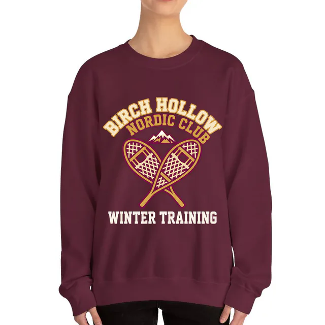Crossed snowshoes for the Birch Hollow Nordic Club, on a maroon adult crewneck