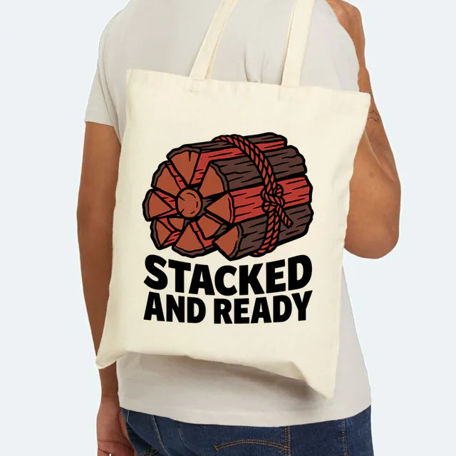 A rope-tied stack of firewood, STACKED AND READY, on a natural canvas tote
