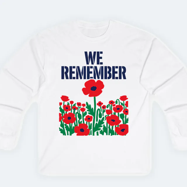 A field of red poppies under WE REMEMBER, on a white adult long sleeve