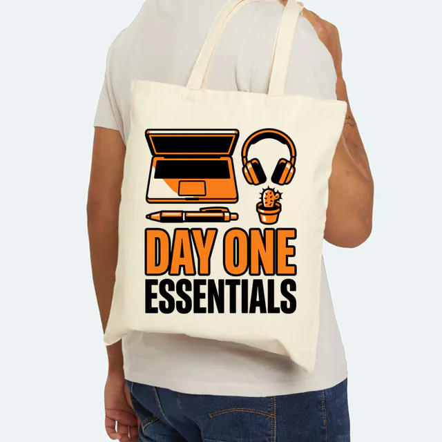 A laptop, headphones and a cactus, DAY ONE ESSENTIALS, on a natural canvas tote