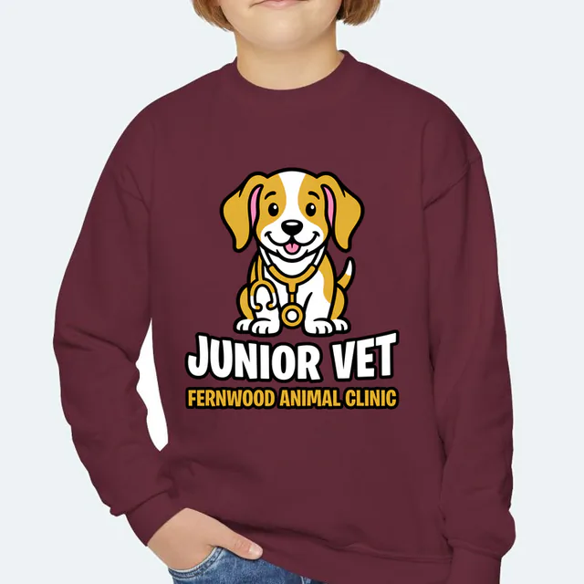 A puppy in a stethoscope, JUNIOR VET, on a maroon youth crewneck