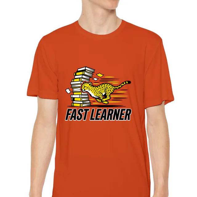 A cheetah cub racing past a stack of books, FAST LEARNER, on an orange youth performance tee