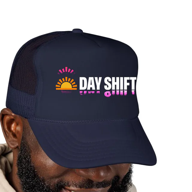 A rising sun beside DAY SHIFT, on a navy foam trucker hat