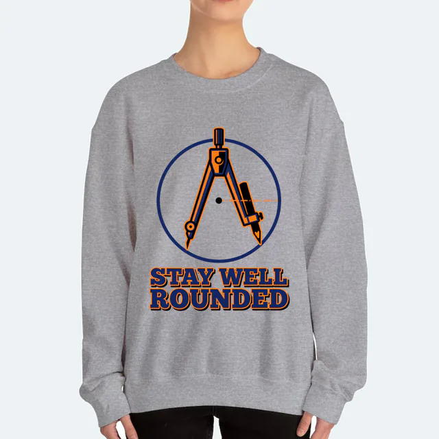 A drafting compass tracing a circle, STAY WELL ROUNDED, on a sport gray adult crewneck
