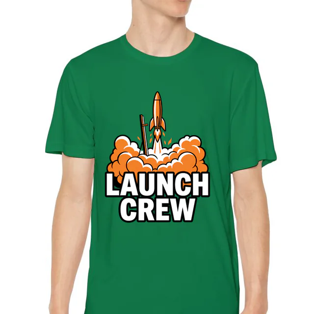 A model rocket lifting off in a puff of smoke, LAUNCH CREW, on a kelly green youth performance tee
