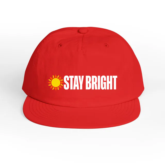 A small sun beside STAY BRIGHT, on a fire surf cap