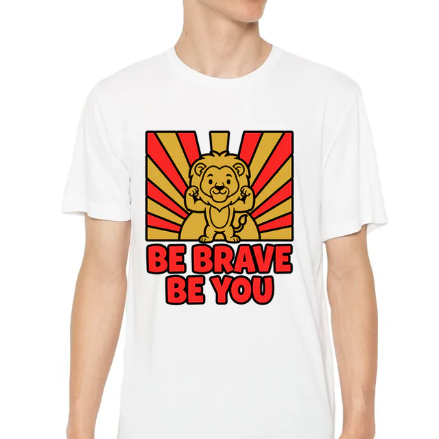 A lion cub flexing before a rising sun, BE BRAVE BE YOU, on a white youth performance tee