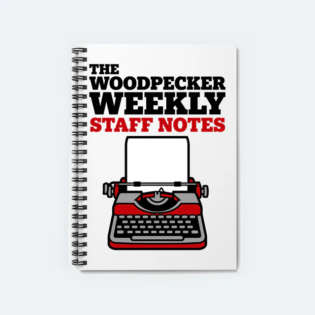 A vintage typewriter for The Woodpecker Weekly staff, on a white spiral notebook