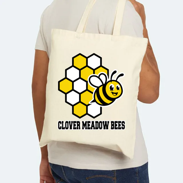 A bee flying out of a honeycomb for the Clover Meadow Bees, on a natural canvas tote